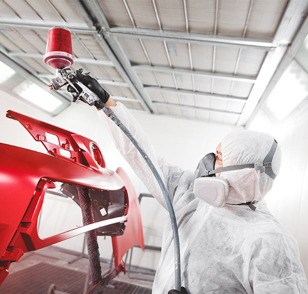 collision repair technician auto painting vehicle in spraybooth at Phil's Auto Body in Rosemount, MN